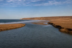 Atlantic lagoon at Khnifiss between ochre cliffs, calm water and an uninhabited desert plateau